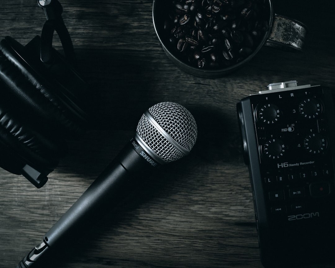 Overhead flatlay of an audio mixing desk with headphones and microphone