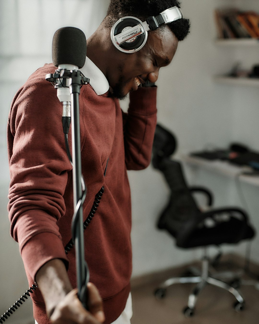 Young presenter practicing at a microphone during live broadcast training